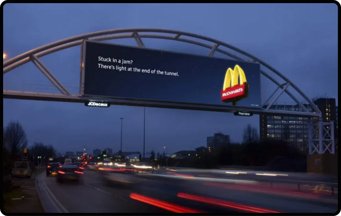 McDonald’s billboard advertisement displayed above a busy road at night